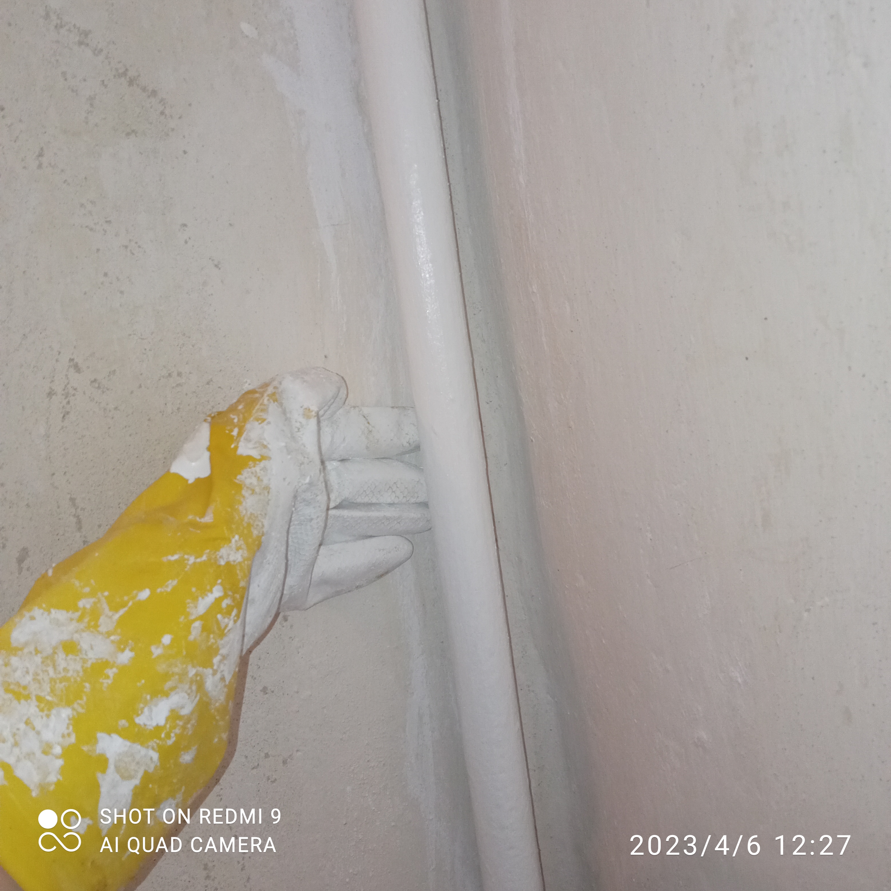 покраска трубы рукой в перчатке